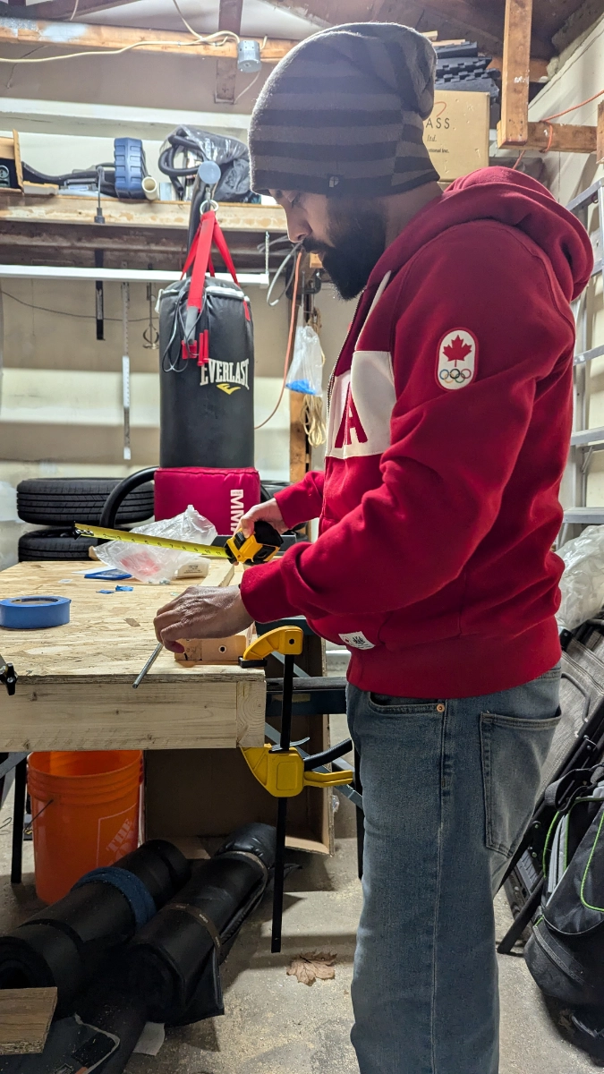 Salim working in a small workshop with tools